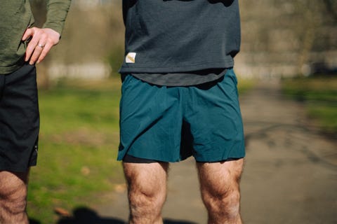 lower half of an unpictured man wearing a pair of light blue running shorts