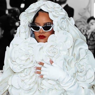 a person wearing a white dress and sunglasses with flowers