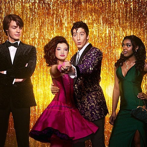 Four teens pose in prom attire in front of a tinsel background in a promotional image for Prom Pact, a Good Housekeeping pick for best kids movies 2023 four teens pose in prom attire in front of a tinsel background in a promotional image for prom pact, a good housekeeping pick for best kids movies 2023