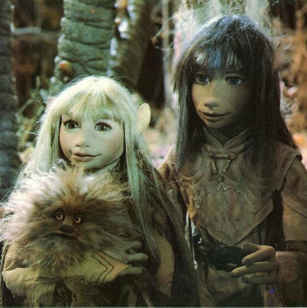 Two gelflings hold an animal in a scene from The Dark Crystal two gelflings hold an animal in a scene from the dark crystal