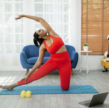 woman doing yoga video in home