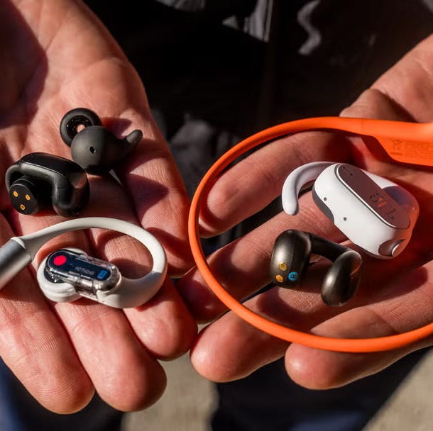 various types of wireless earphones and headphones held in two hands various types of wireless earphones and headphones held in two hands