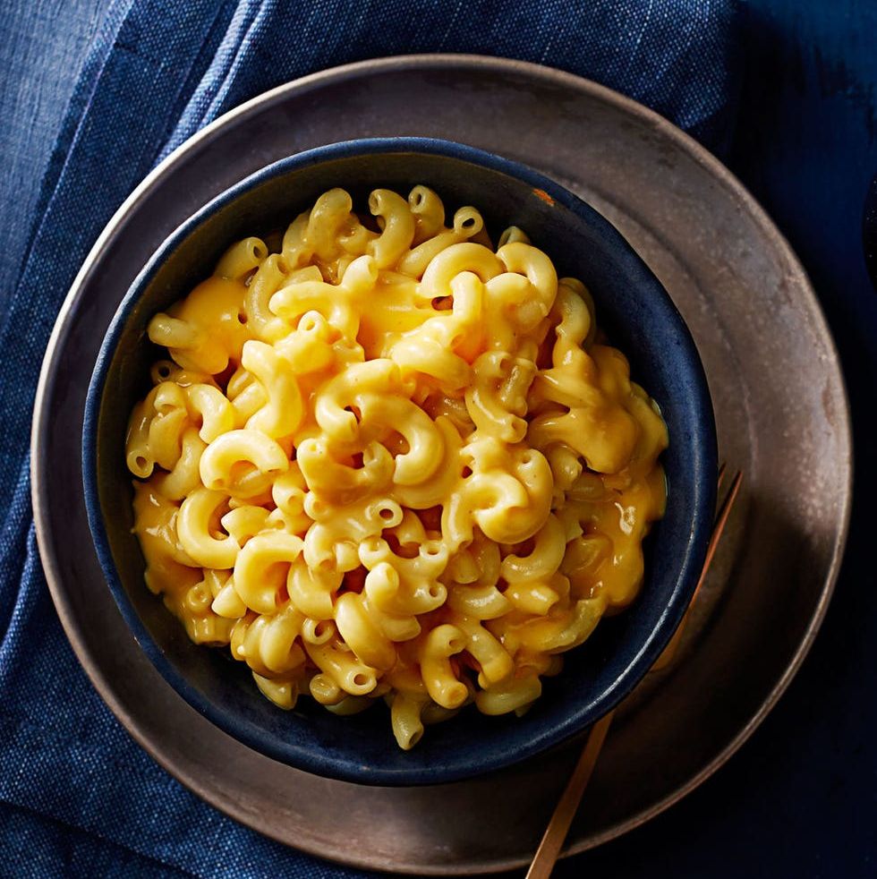 stovetop mac 'n' cheese in a blue bowl on black plate
