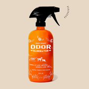 an orange bottle of pet odor eliminator with a black spray nozzle