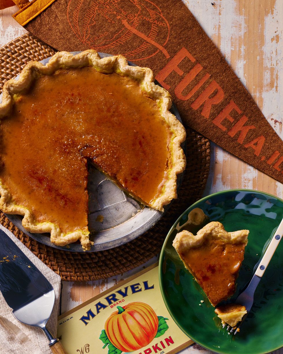 easy pumpkin pie in a metal pie plate with bruleed sugar on top and a slice removed and on a green plate with a fork