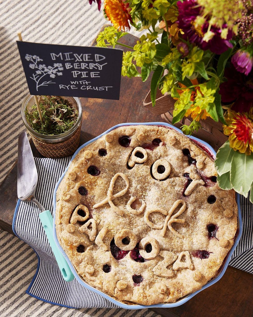 mixed berry pie with rye crust in a colorful patterned pie plate with light blue trim