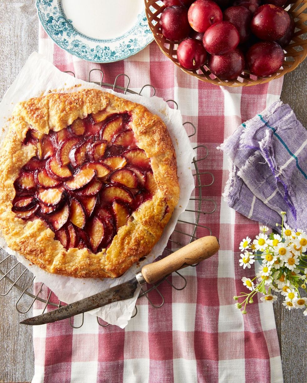 spiced plum galette on a parchment lined wire rack