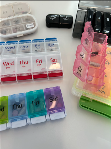several pill organizers on a tabletop