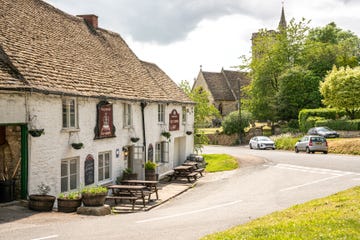 the cotswold village of uley with the old crown country pub and the church of saint giles, united kingdom