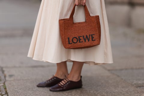 berlin, germany august 22: sonia lyson seen wearing zara creamy white long pleated skirt, loewe cognac brown logo raffia bag and zara burgundy leather ballerinas, on august 22, 2024 in berlin, germany. (photo by jeremy moeller/getty images)