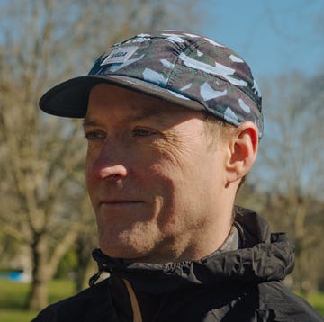 best running cap a person wearing a camouflage patterned cap in an outdoor park setting