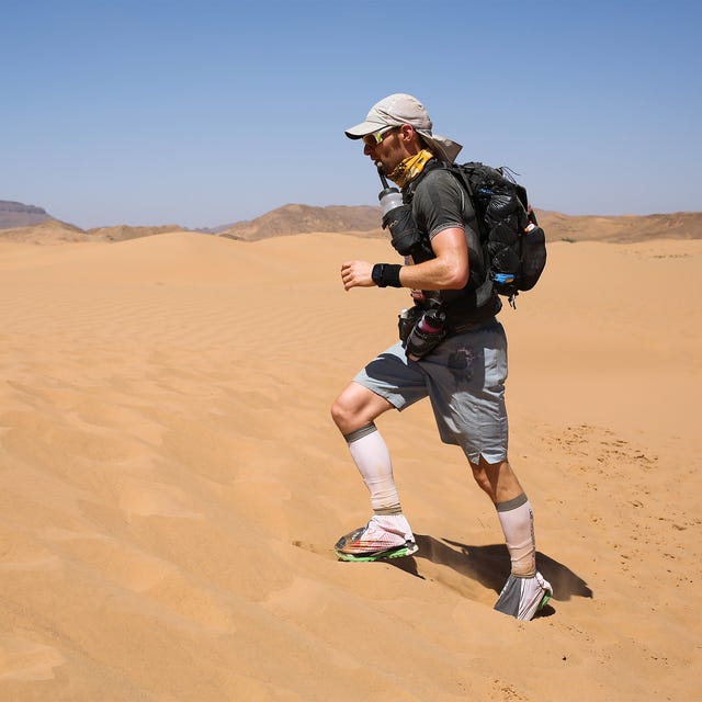 a man running through the desert wearing an array of running kit a man running through the desert wearing an array of running kit
