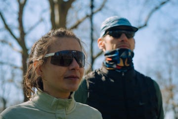 close up of a man and a woman looking off into the distance wearing large wrap around sunglasses