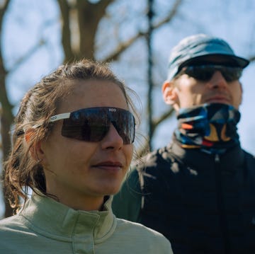 best running sunglasses close up of a man and a woman looking off into the distance wearing large wrap around sunglasses