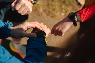 a group of runners comparing running watches