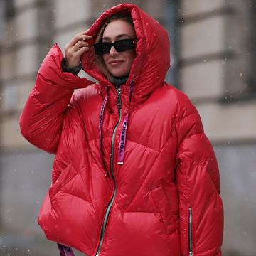 woman wearing jacket and glasses in snow