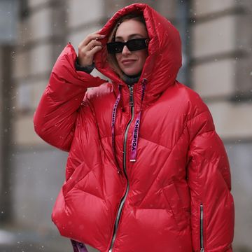 woman wearing jacket and glasses in snow