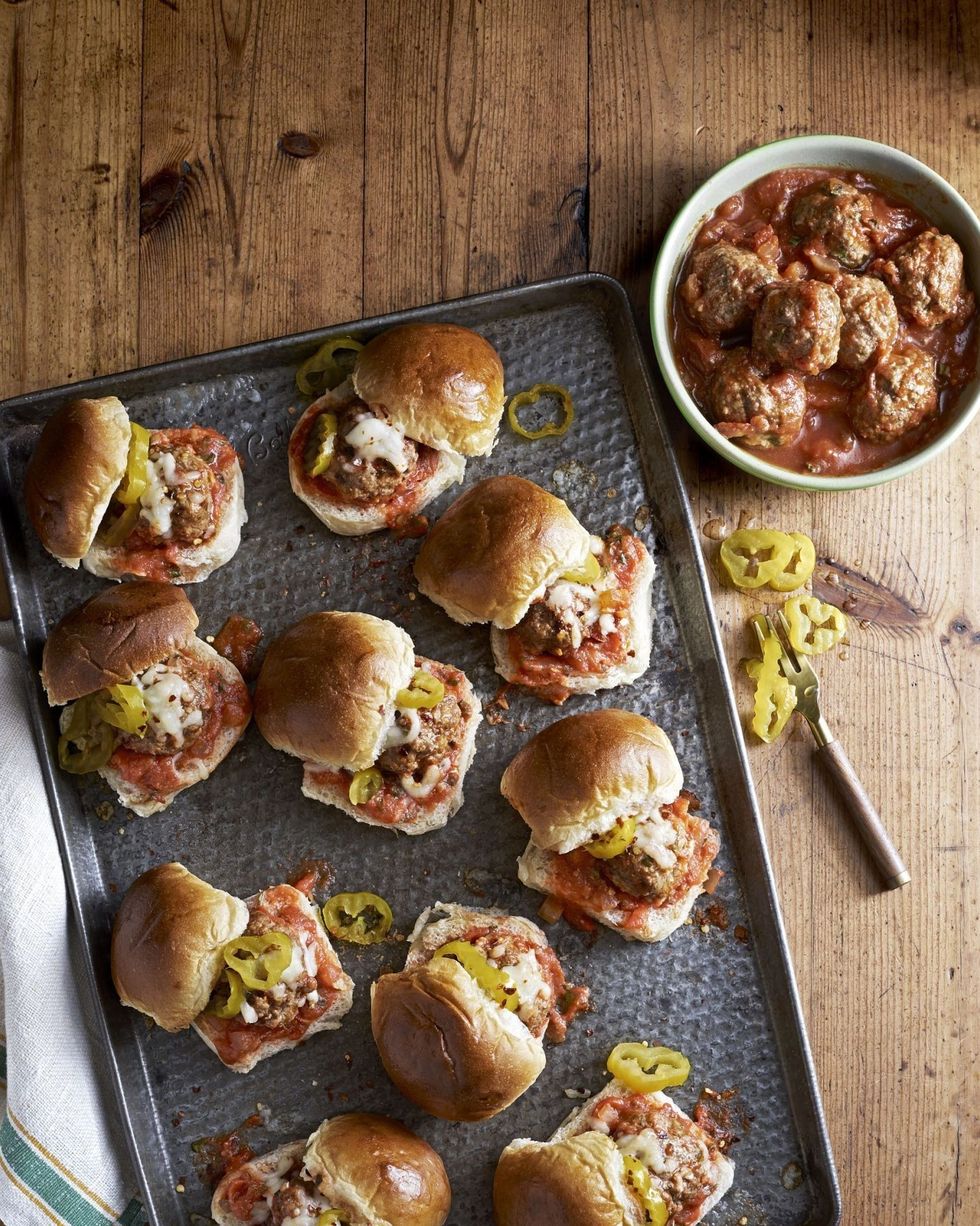 slow cooker meatballs served on slider buns with sliced banana peppers