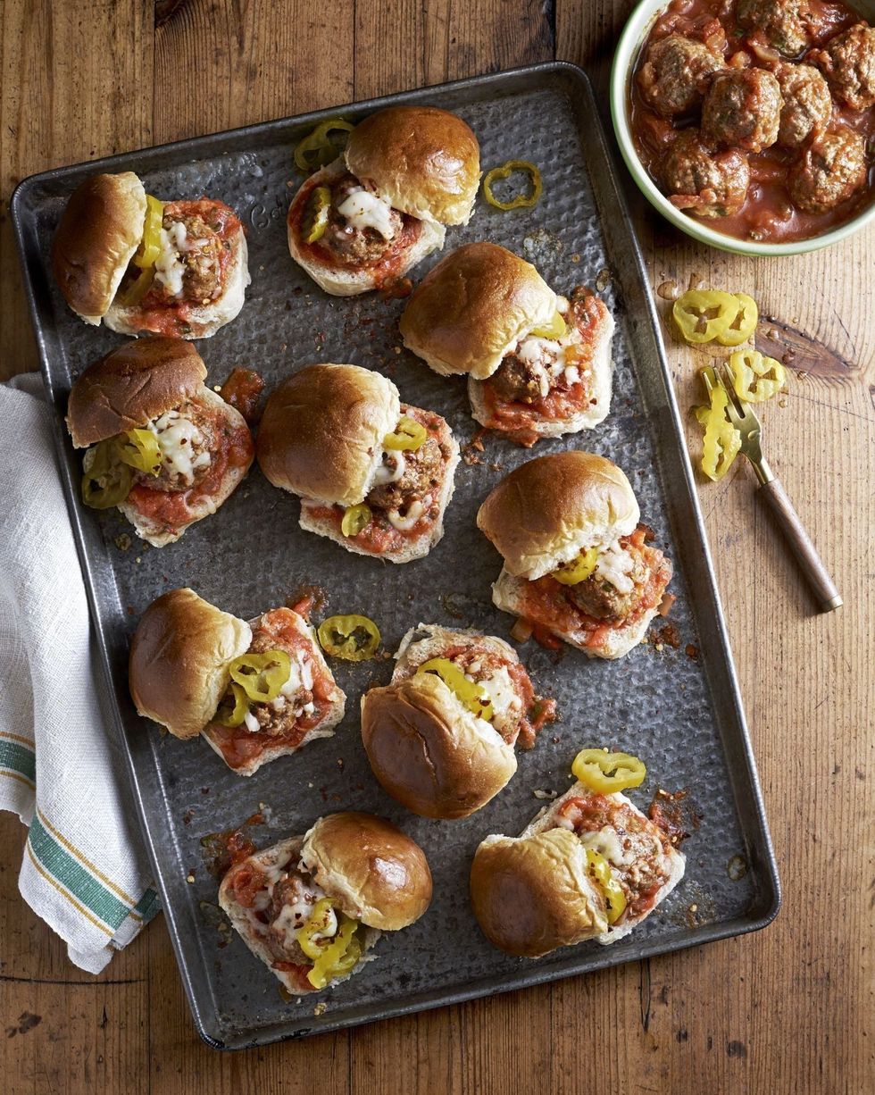slow cooker meatballs served on slider buns with sliced banana peppers