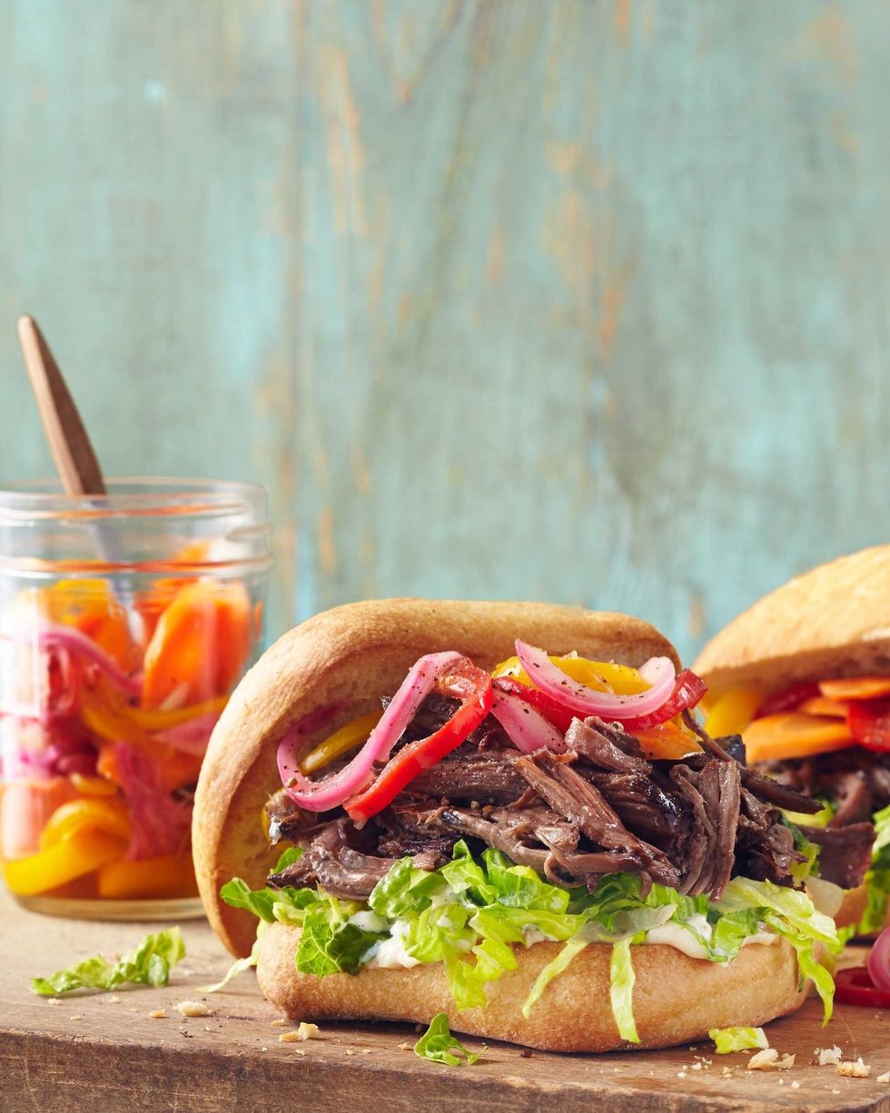 slow cooker roast beef sandwiches with lettuce and mayo and giardiniera on buns