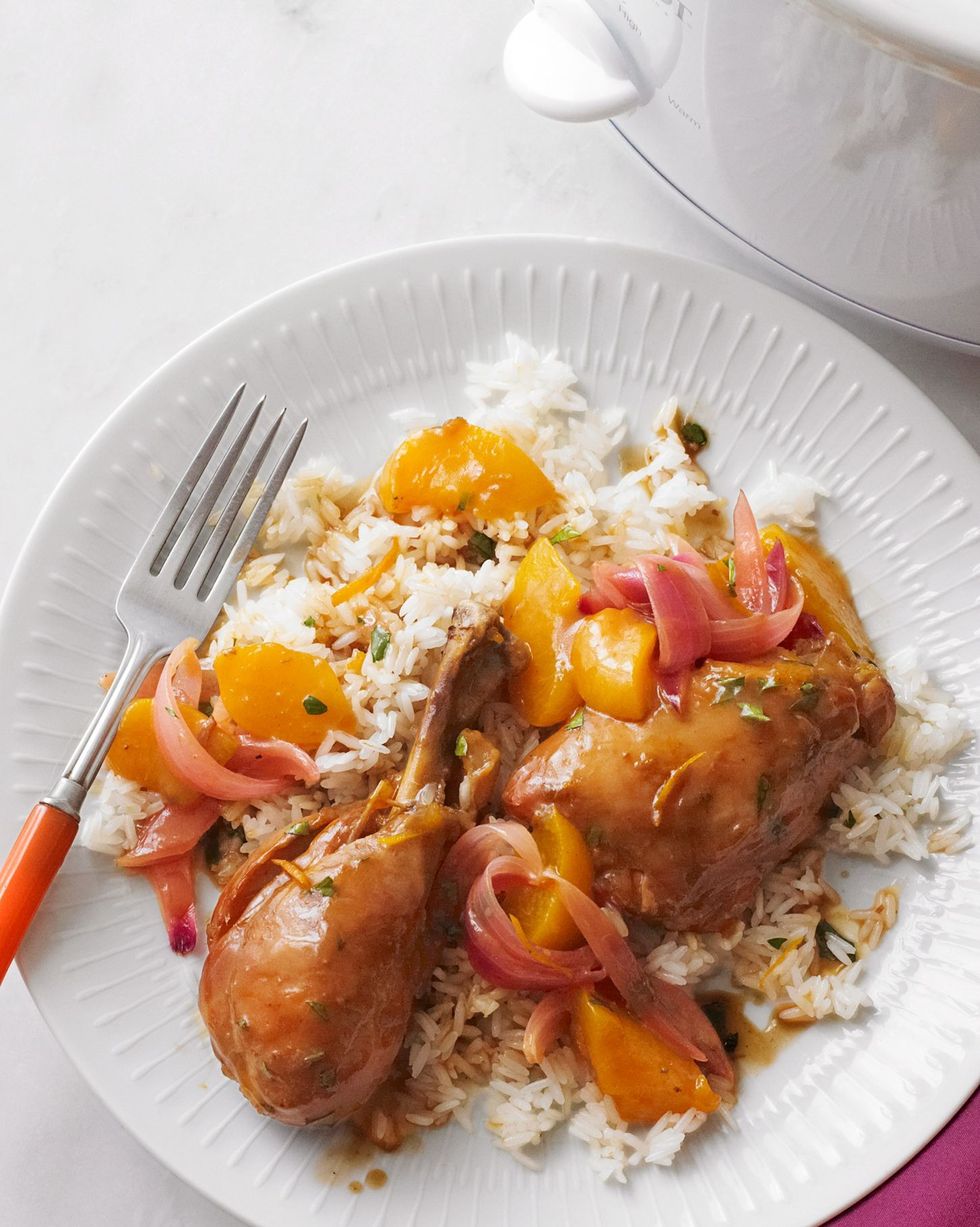 slow cooker sweet and sour chicken served over rice on a white plate