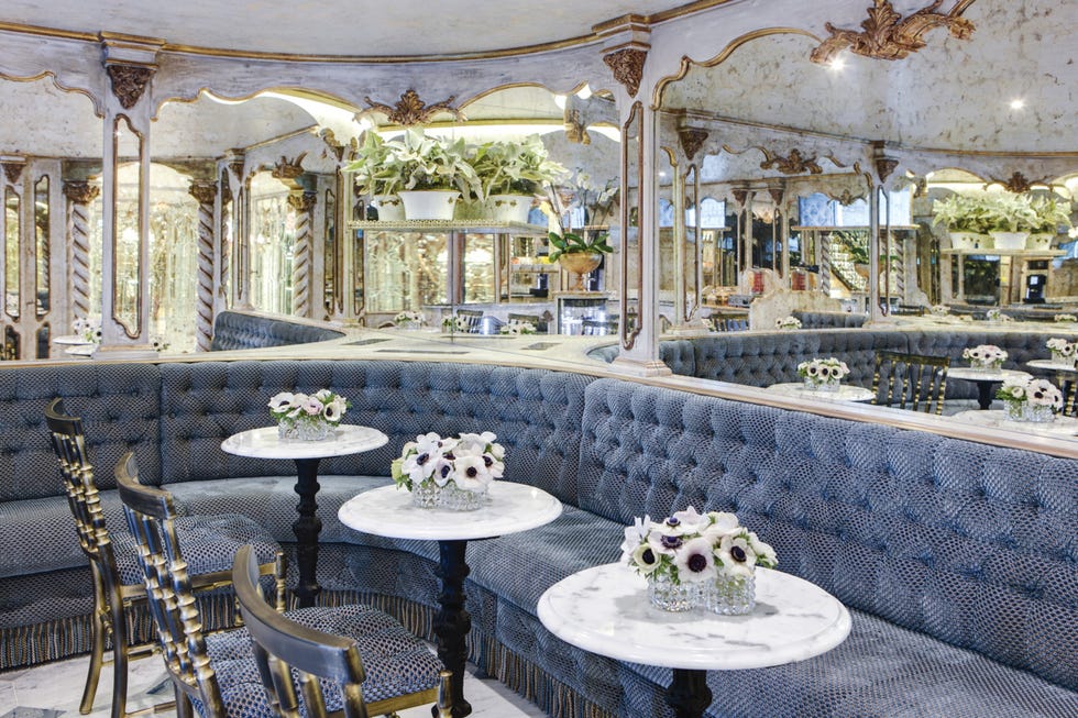 elegant cafe interior with plush seating and floral arrangements