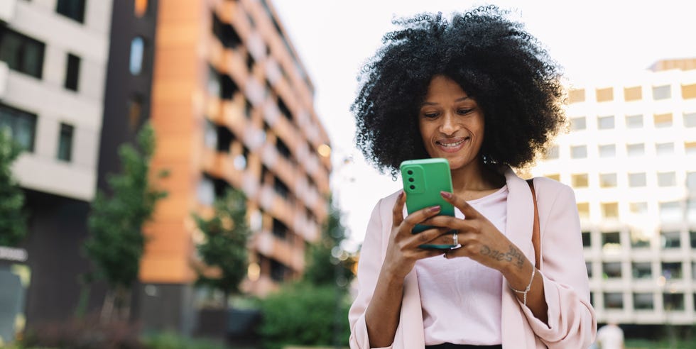 Best smartphones woman using a smartphone outdoors in an urban setting