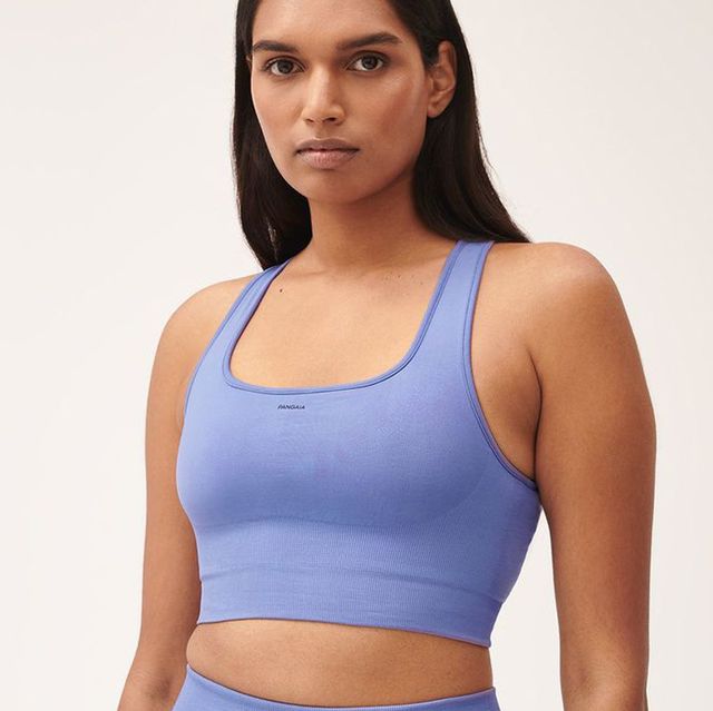 a woman wearing a blue tank top and a photo of a black sports bra