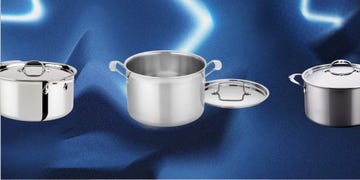 three stainless steel cooking pots on a blue background