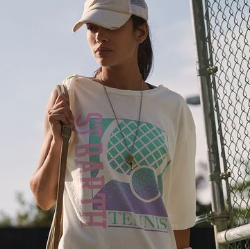 a chic grey tennis skirt and a woman in a tennis t shirt and visor looking fashionable and cool