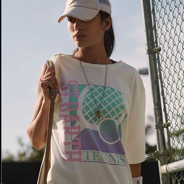 a chic grey tennis skirt and a woman in a tennis t shirt and visor looking fashionable and cool