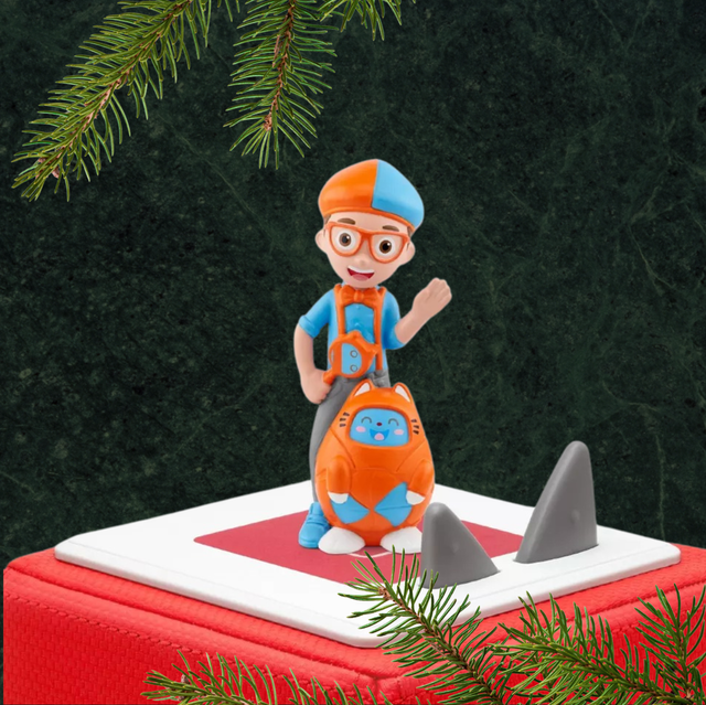 The Blippi Tonies figure standing on a toniebox against a festive background the blippi tonies figure standing on a toniebox against a festive background