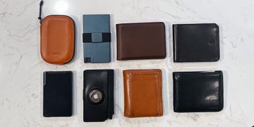 a variety of wallets and card holders arranged on a surface