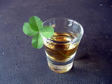 whiskey in shot glass with four leaf clover