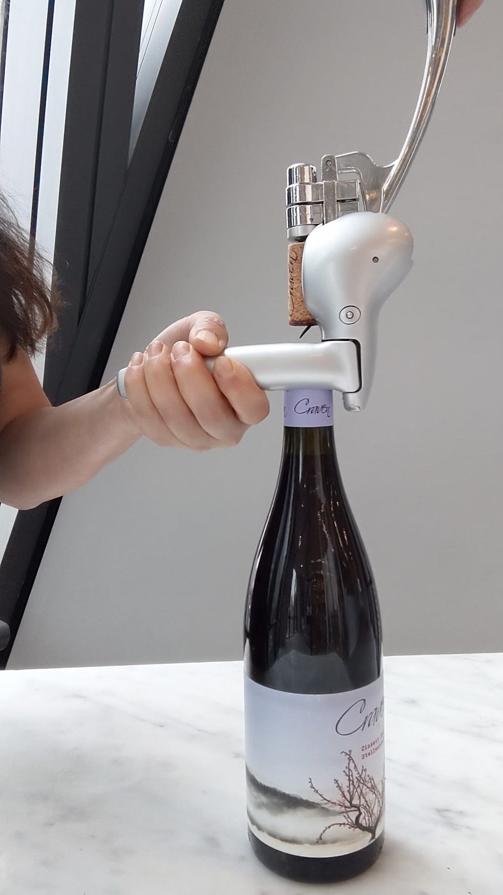 best wine openers wine bottle being opened with a lever style corkscrew