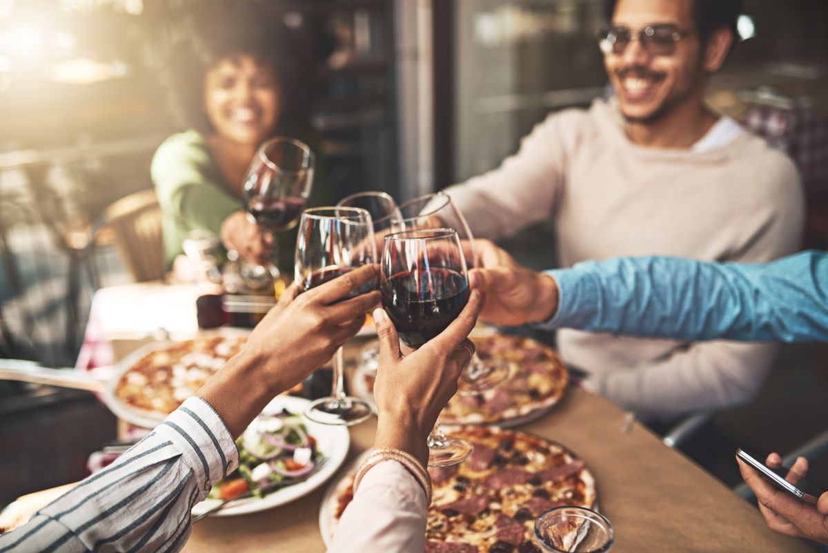 friends with wine and pizza