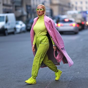 a person in a garment walking down the street