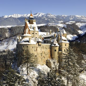 bran castle in winter with snow and bucegi mountainsmore pictures with draculas bran castle in my portfolio