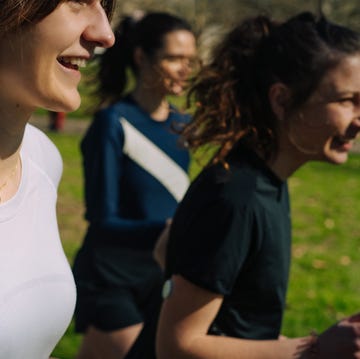 best women's running tops close up of three women running outside