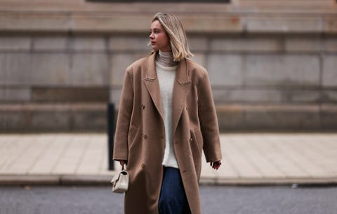 a woman wearing a brown coat