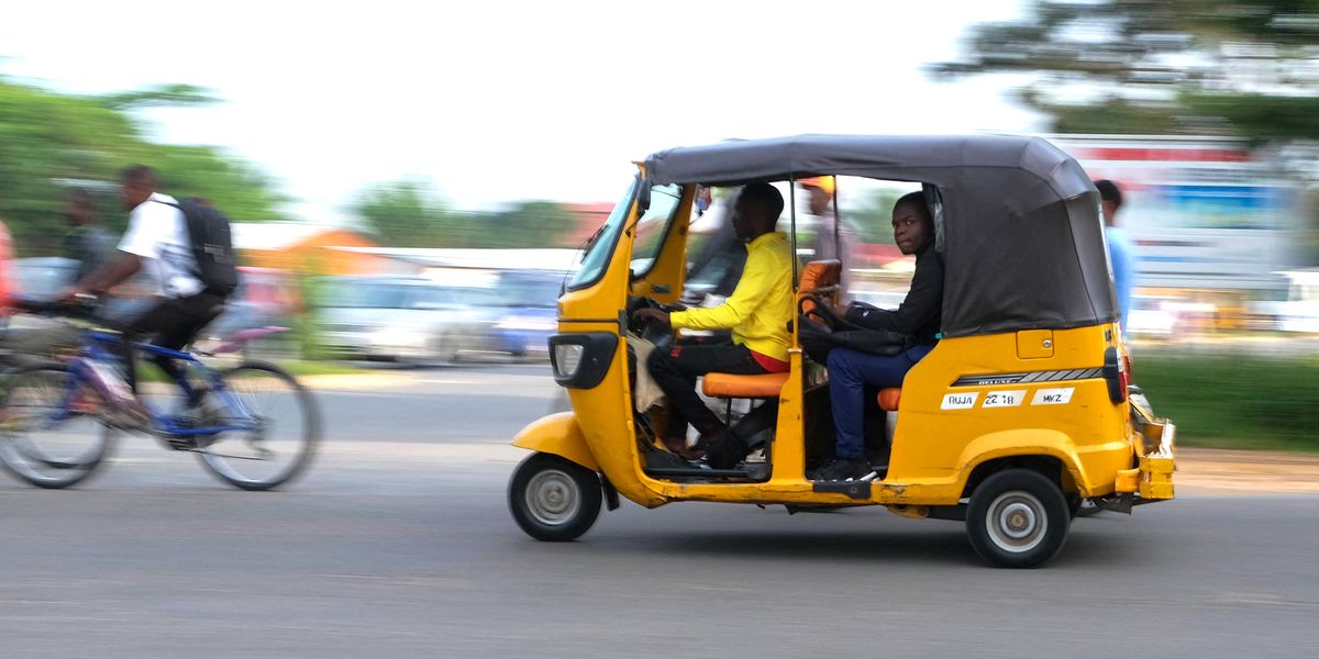 a tuk tuk taxi driver speeds through traffic in bujumbura