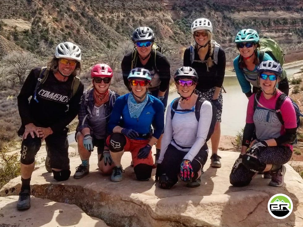 a group of people wearing bike helmets and posing for a photo