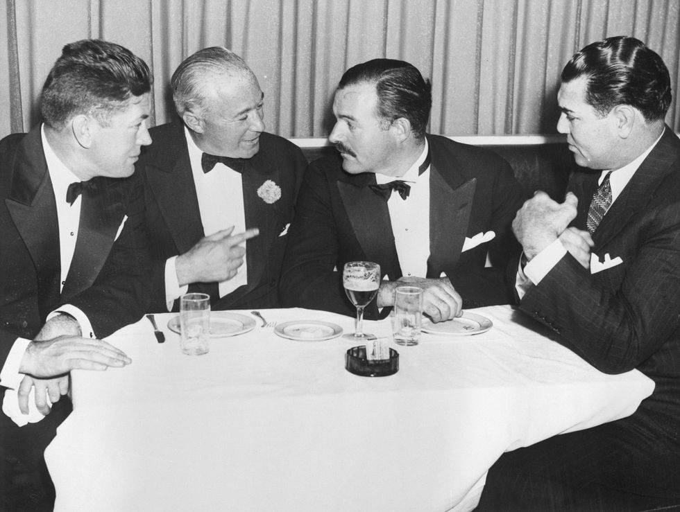original caption 1935 new york, ny left to right gene tunney, bernard gimbel, ernest hemingway, jack dempsey, at dempseys restaurant