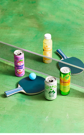 assorted beverages on a ping pong table