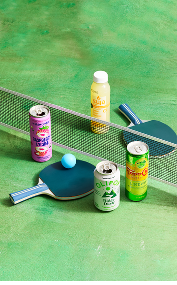 assorted beverages on a ping pong table