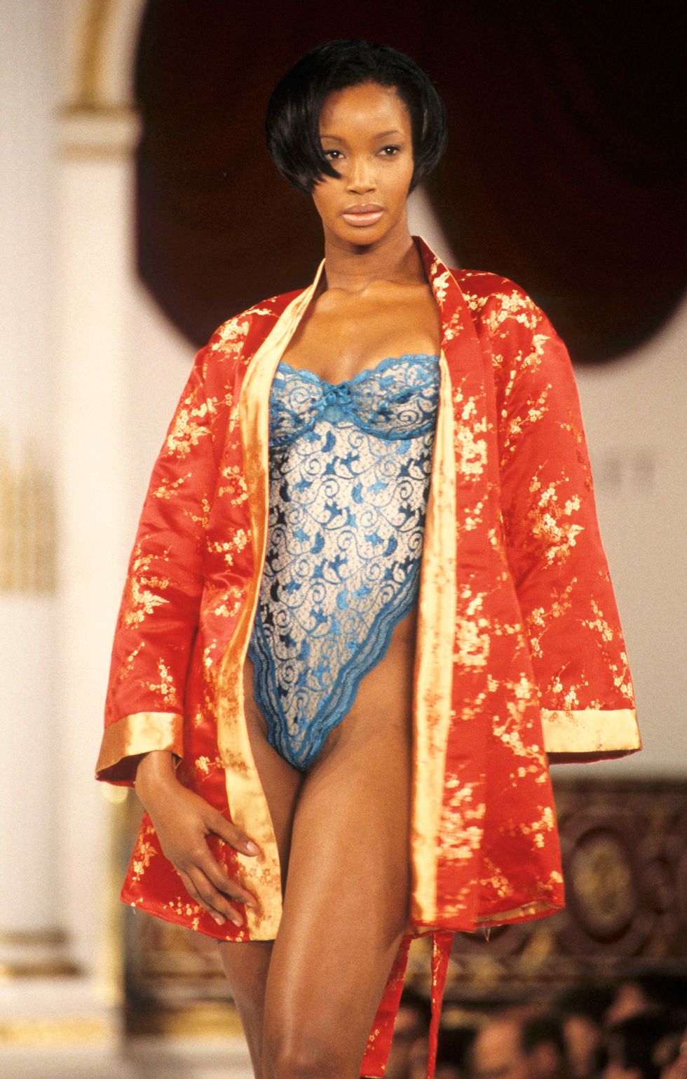 beverly peele wearing a blue bodysuit and orange kimono at the victoria's secret fashion show in 1995