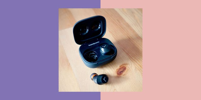 beyerdynamic amiron 300 wireless earbuds with charging case on a wooden surface