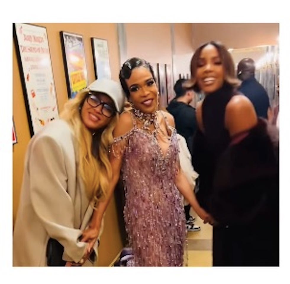 group of people in a hallway one wearing a glamorous purple dress