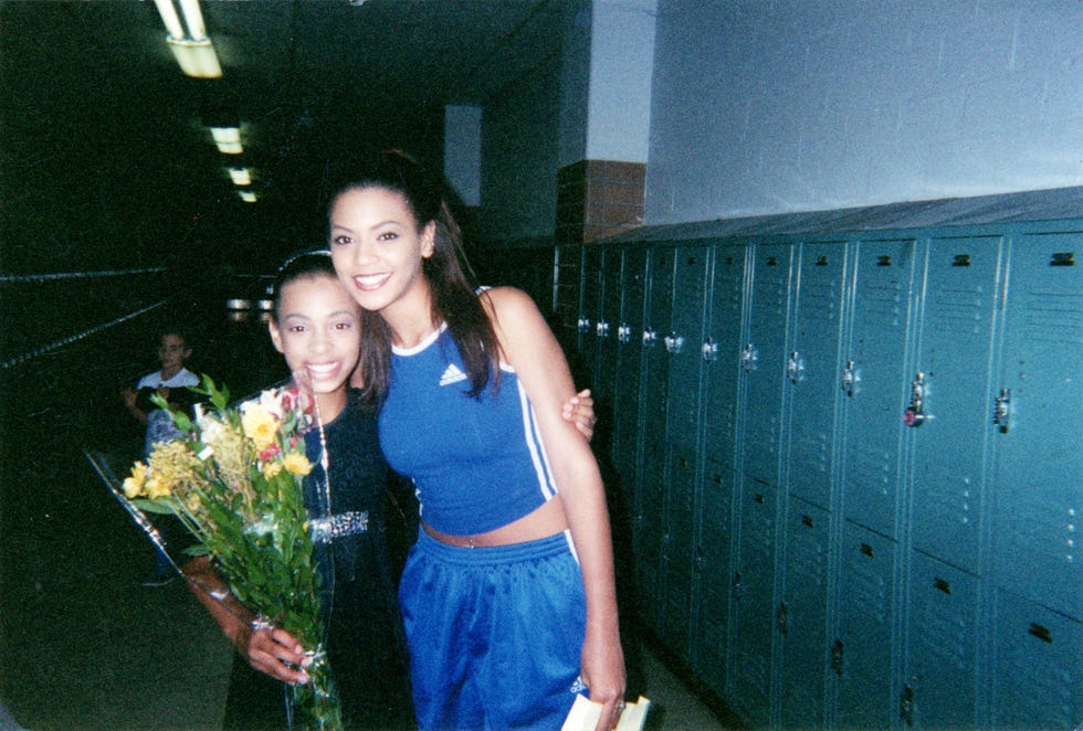 beyoncé and solange knowles in a school hallway with lockers celebrating an occasion