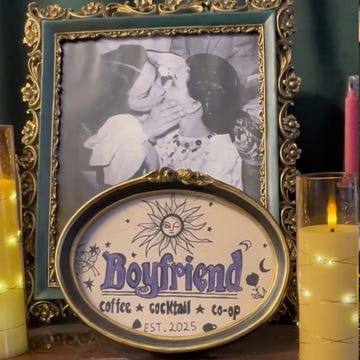 Boyfriend Co-Op a coffee and cocktail coop establishment featuring a framed photo of women kissing and a drink special